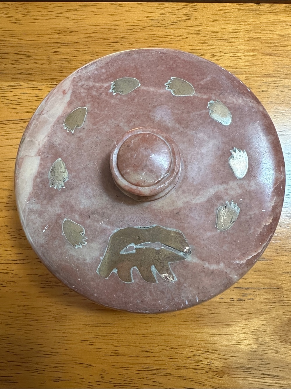 Soapstone trinket box with brass bear and paw prints inlaid. Hand carved.